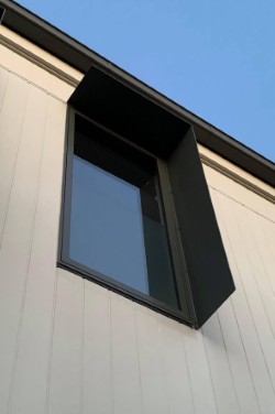 Matte black aluminium window shroud on white cladding — Melbourne bayside home